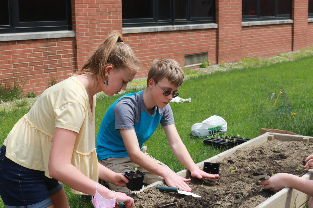Two TMS students working in the garden.