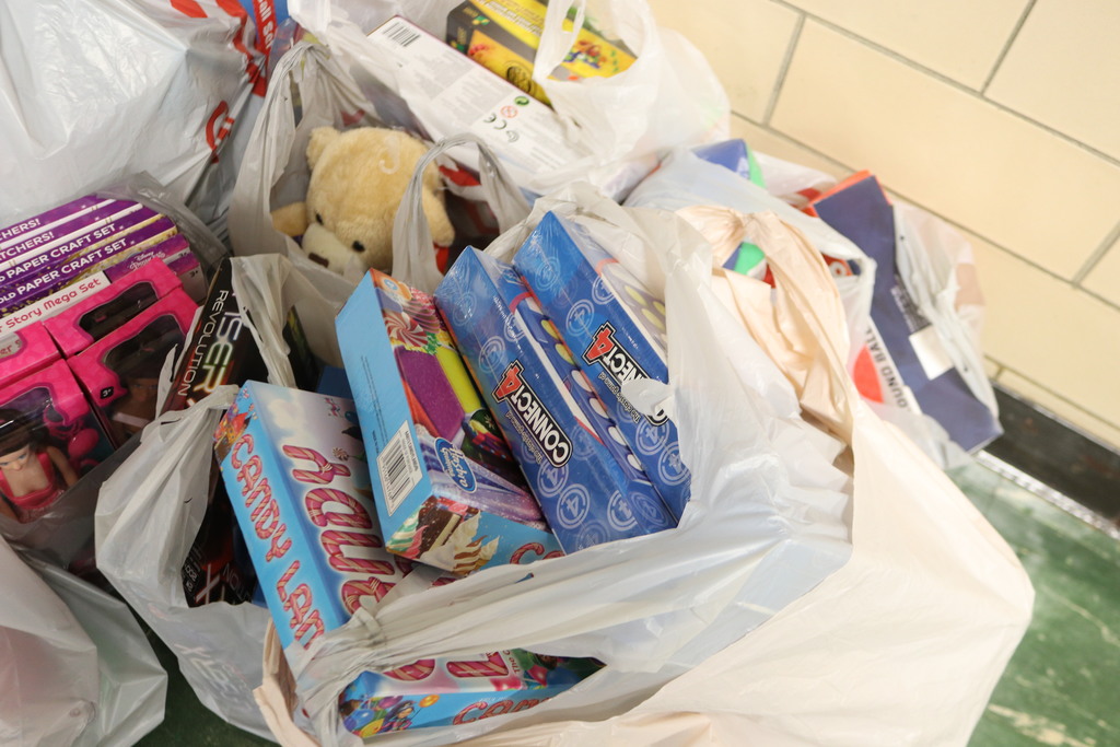 Donated toys in shopping bags.