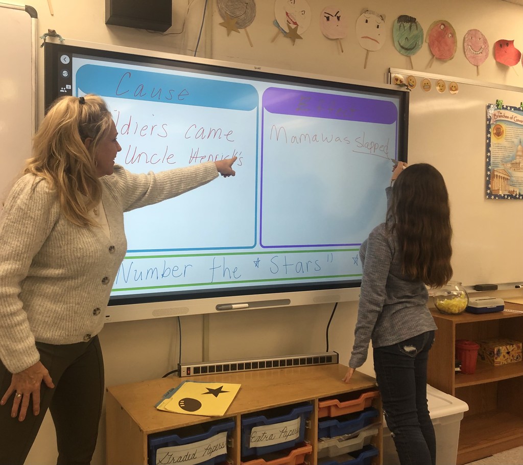 Teacher and student collaborating at the new smartboard