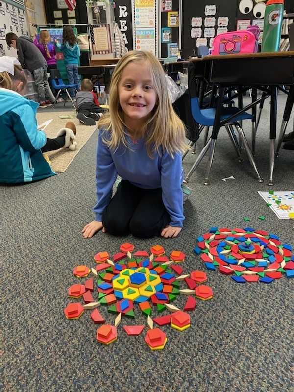 A first grader shows off her "snowflake."