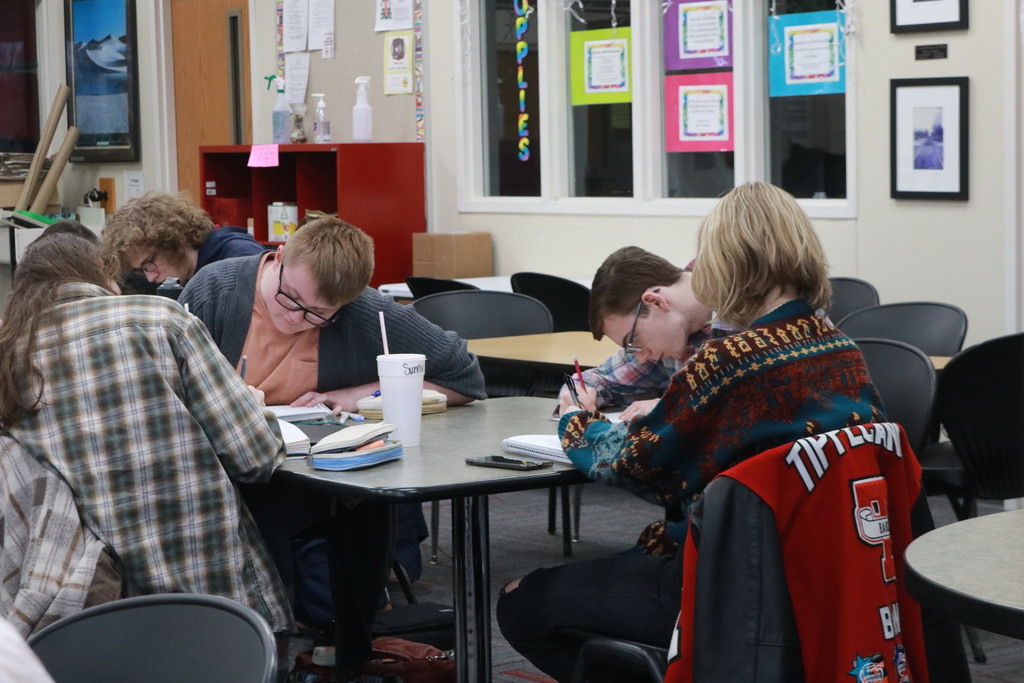A group of students writing at a narrative writing workshop