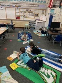 Students reading on their beach towels.