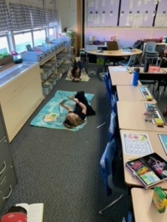 NC students enjoying a book while lounging at the "beach."