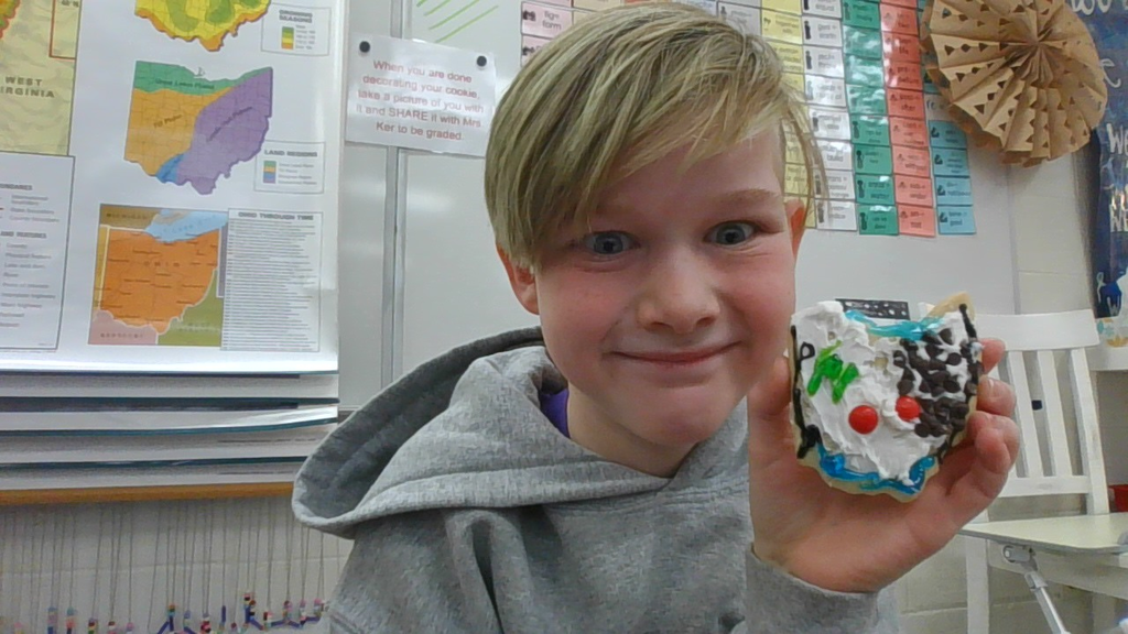 LT Ball student holding his sugar cookie he decorated.