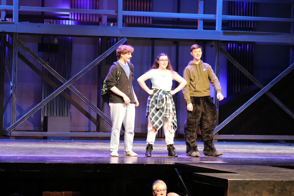 Three students performing during the spring musical.
