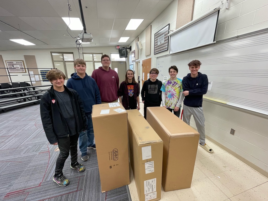 THS band students with the boxes containing a new instrument.