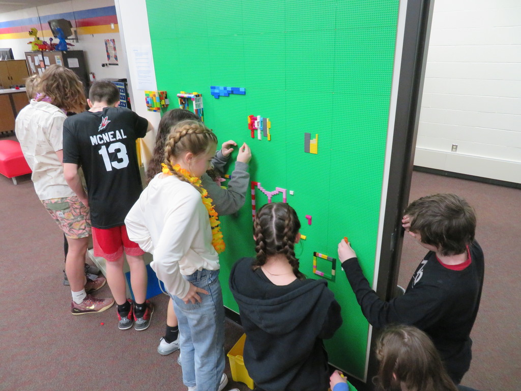 TMS students are deep in thought as they collaborate at the Lego Wall