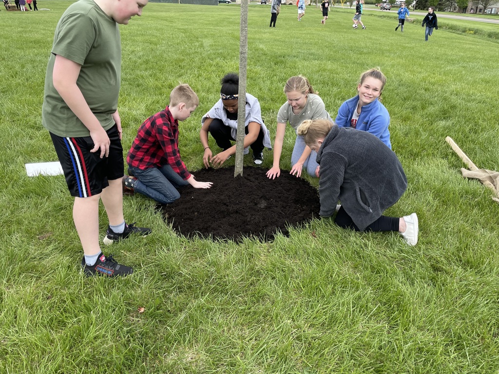 Students help plant trees at TMS.
