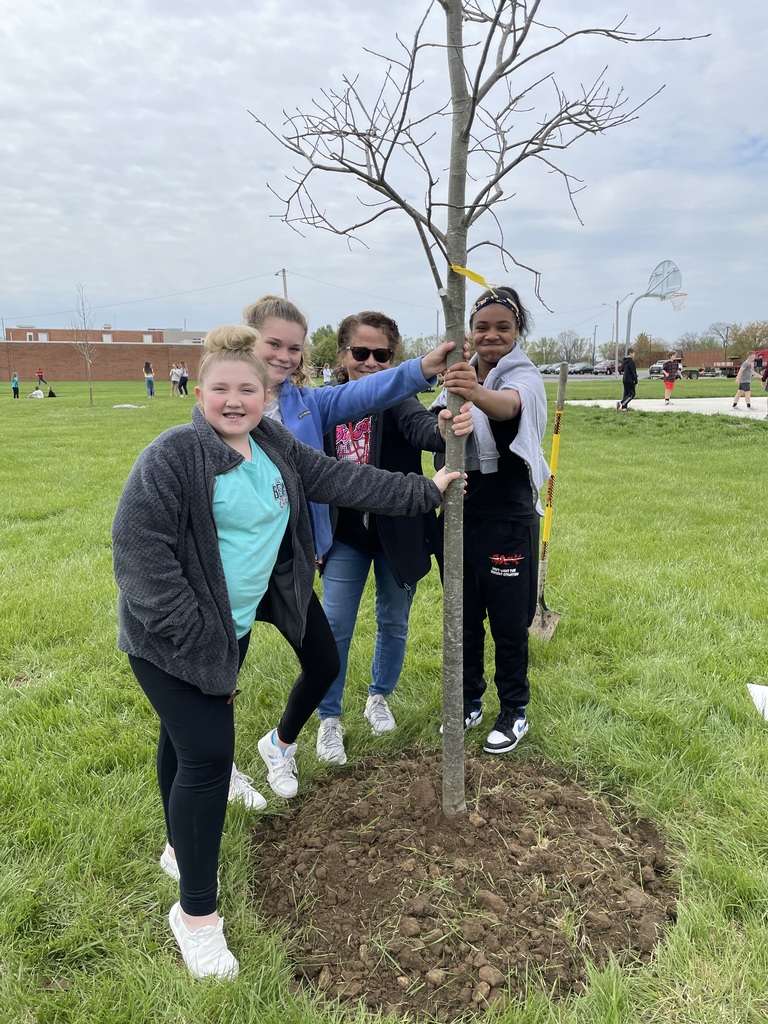 Students stand with the newly planted tree at TMS