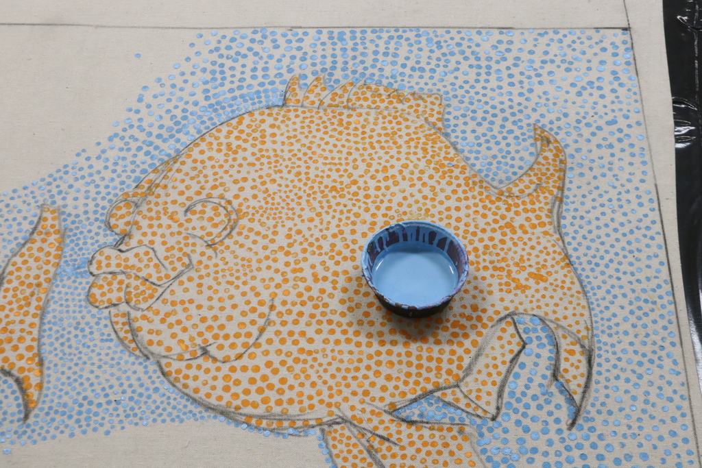 Image of a fish in the water using the painting technique pointillism.