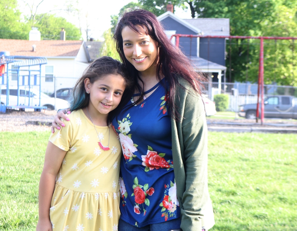 A mom and her daughter are all smiles.