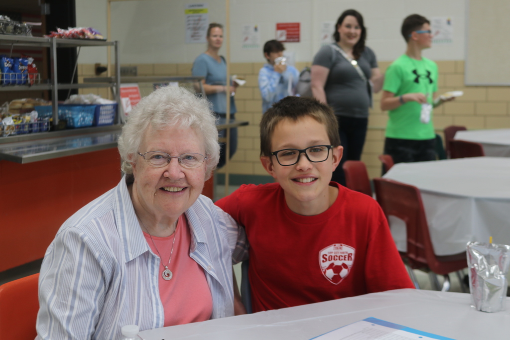 TMS students with his grandma at the Mother's Day Tea