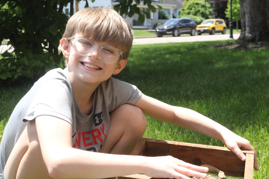 A 3rd grader is all smiles as he mine for gems.