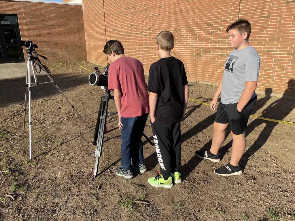 TMS students looking through a telescope as they study about the sun and moon.