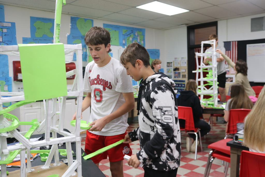 Two TMS students consult with each other to determine what adjustments should be made to their design.
