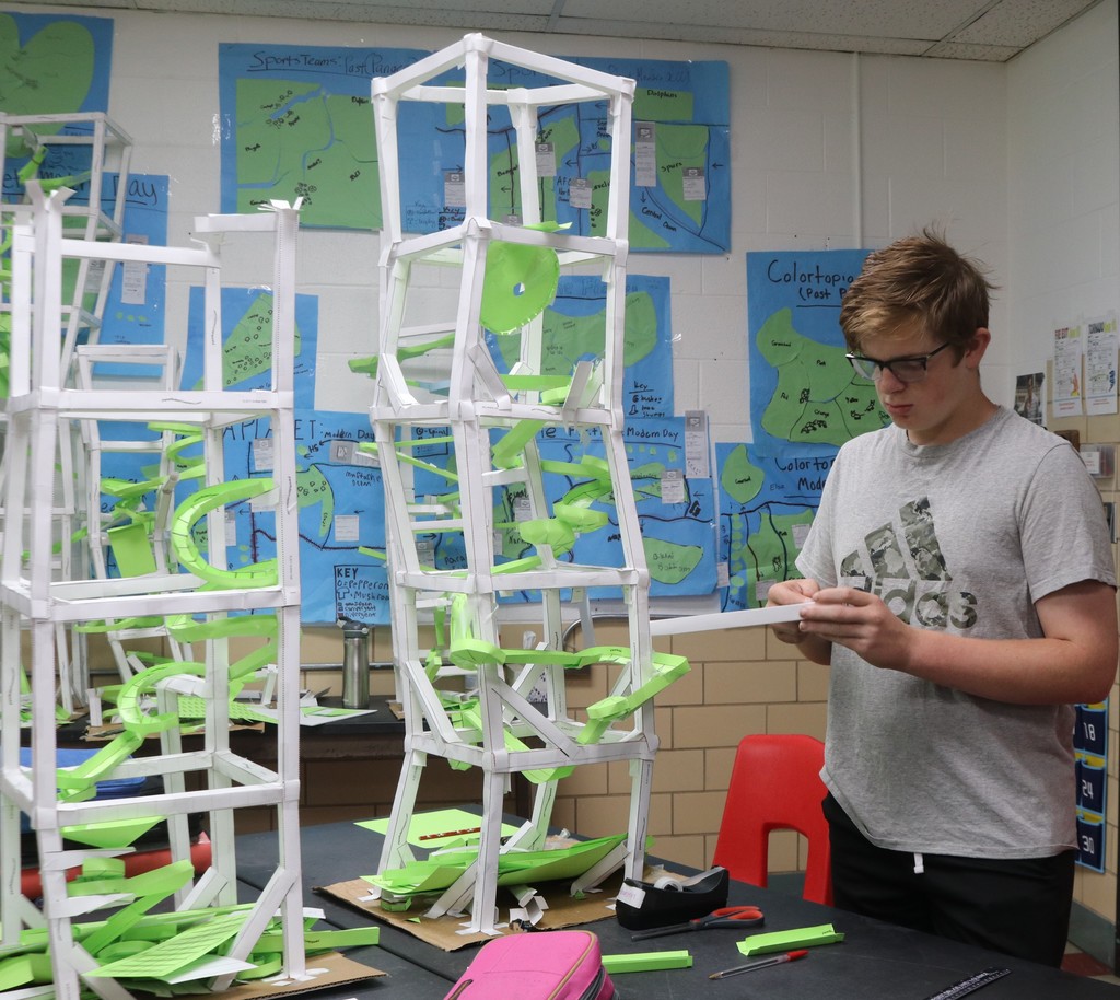 A TMS 8th grader works on his tall roller coaster.