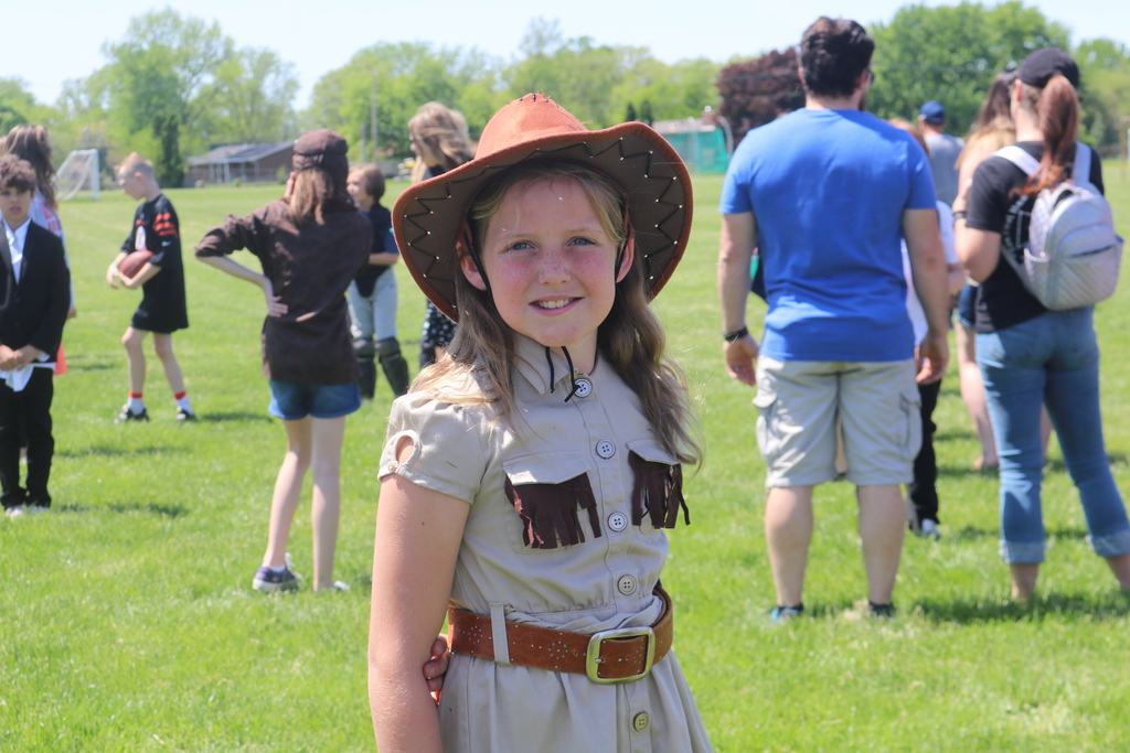 A 5th grader waits for someone to activate her character at the wax museum.