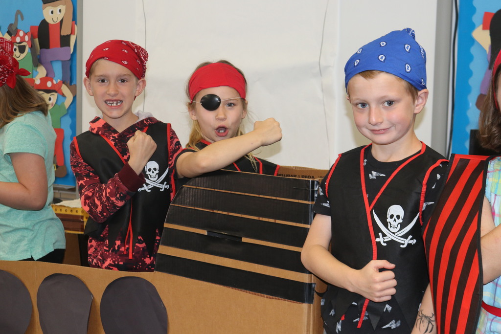Three little pirates get ready for their play.