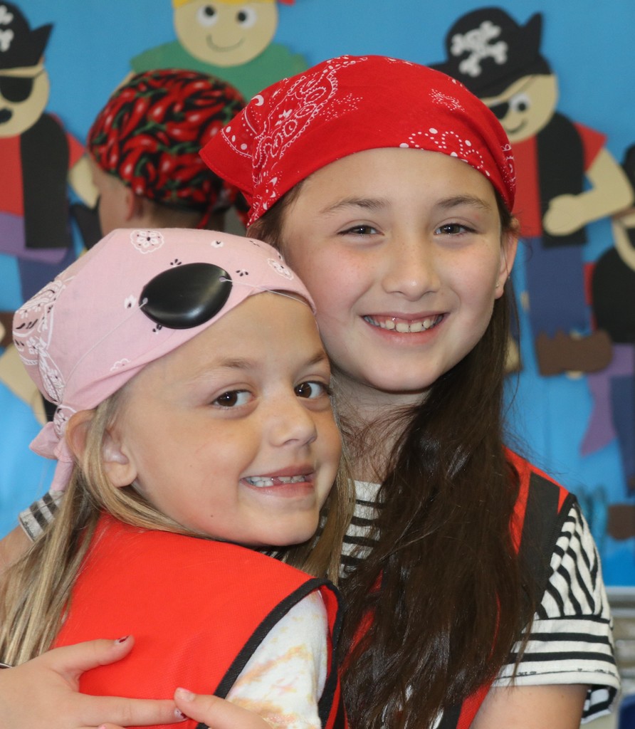 Two of Mrs. Sowder's students dressed as pirates smile and hug.