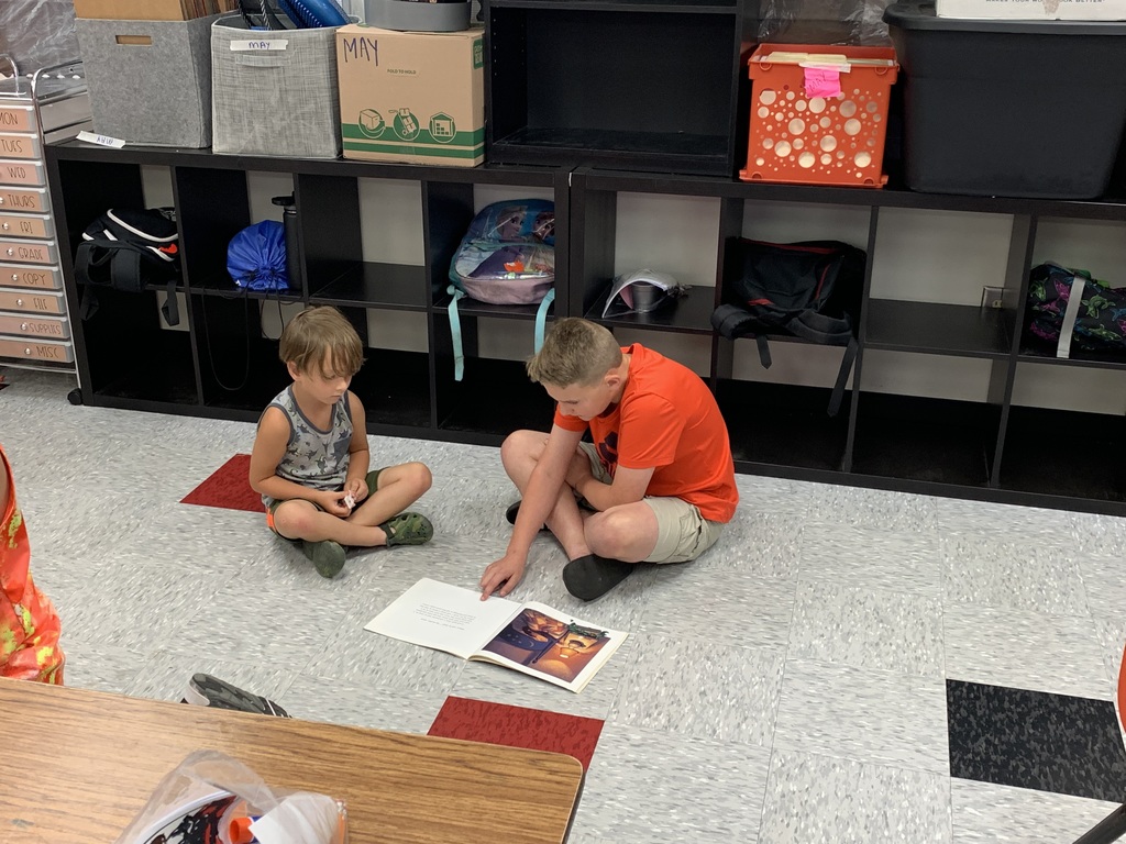 Students at summer school reading together.
