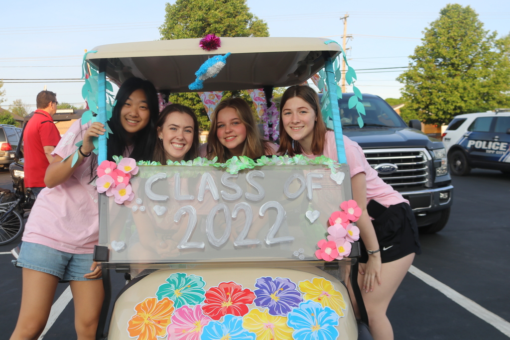 Class of 2022 girls in golf cart for the parade to school.