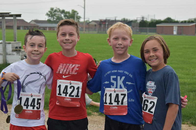 Four boys pose for a picture.