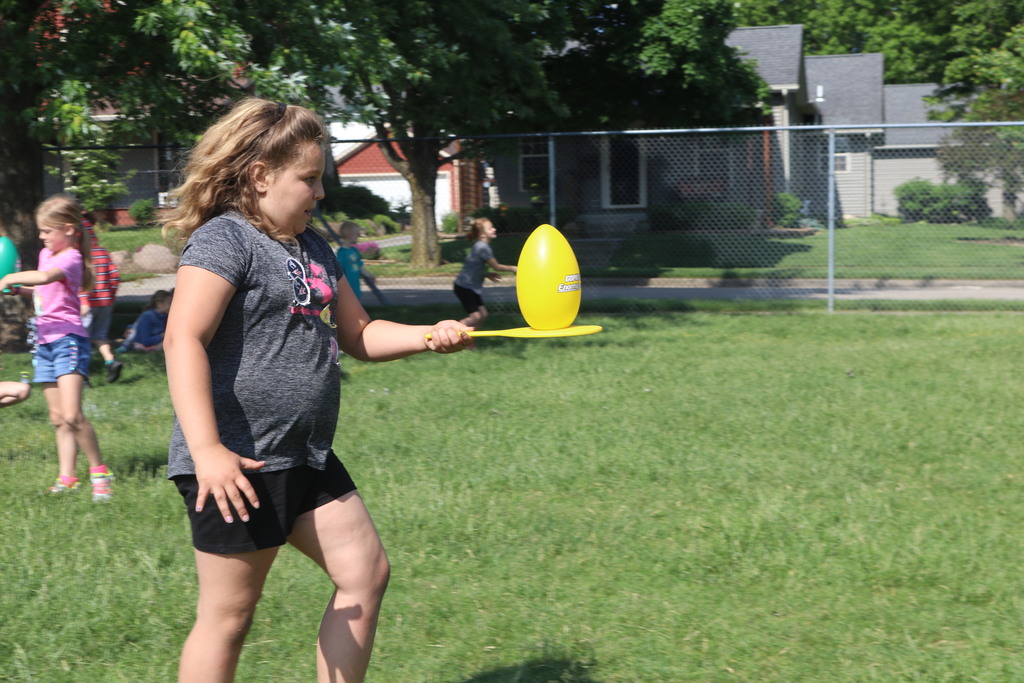 A Broadway student balances a large egg during field day.  