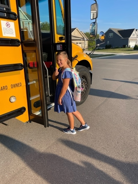 A students gets on the bus.