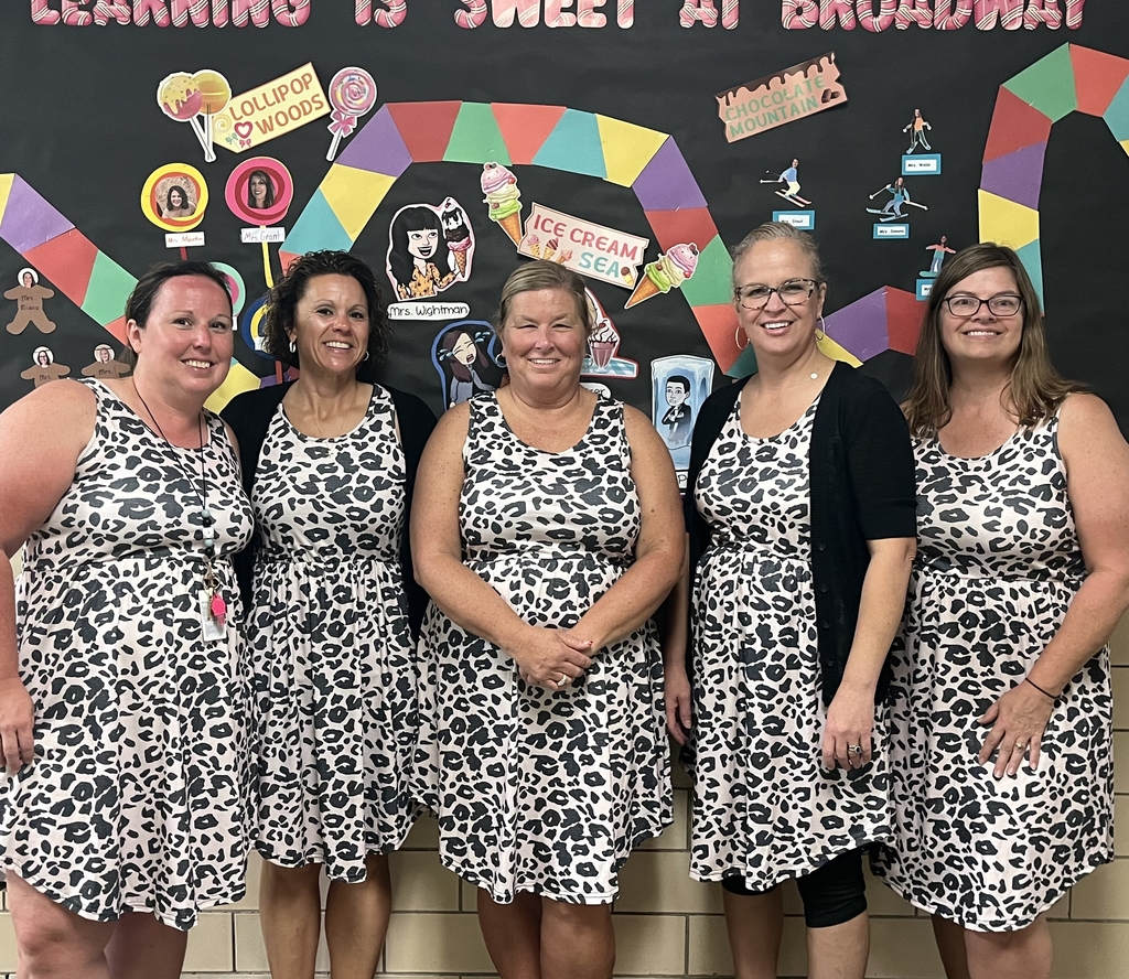 Five Broadway employees are all smiles as they aredressed in the same outfit.