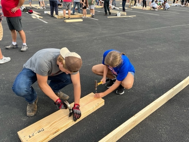 Two THS students work on a house for Habitat for Humanity.
