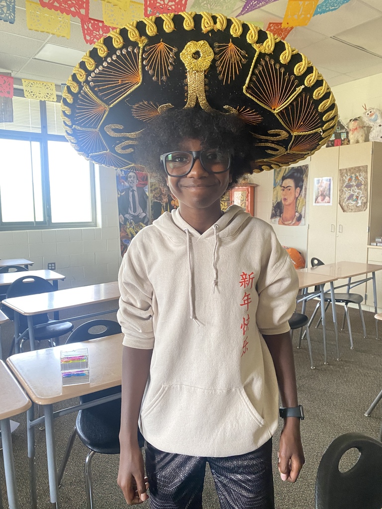 A student poses wearing a sombrero