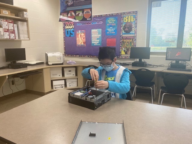 THS student disassembles a computer.