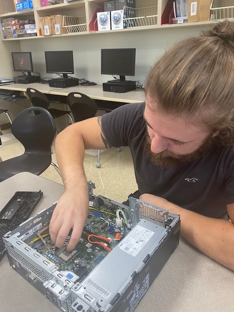 THS student takes apart computer.