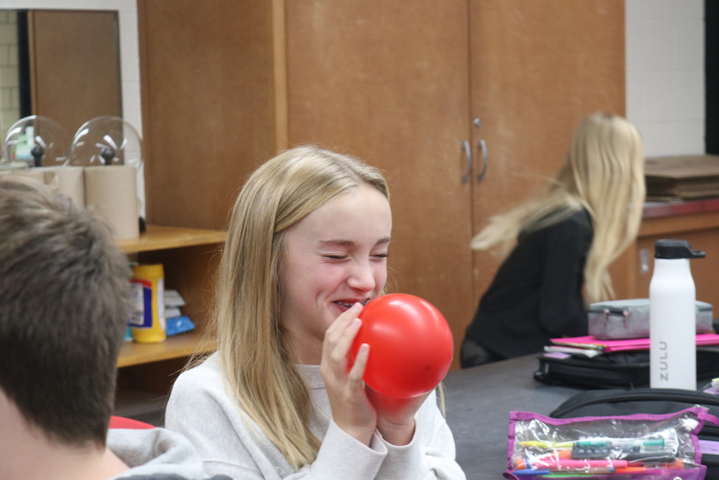 TMS student blowing up a balloon.