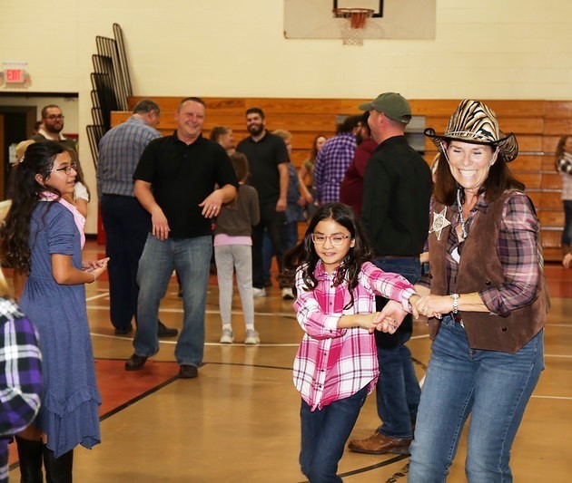 Jeanne Koch dances with a student.