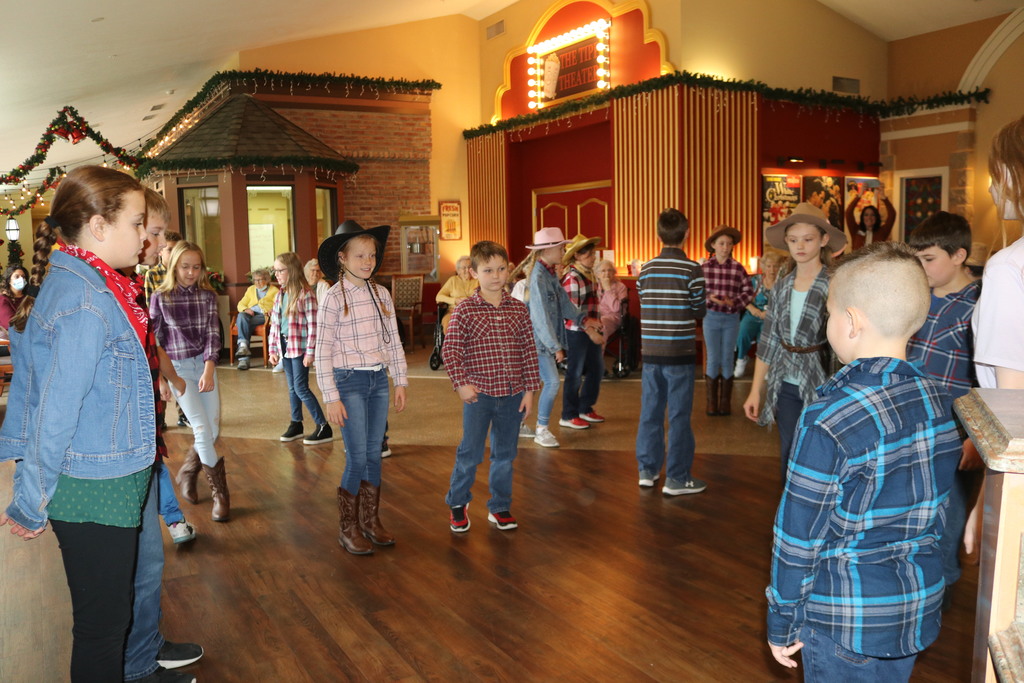 Students perform a square dance.
