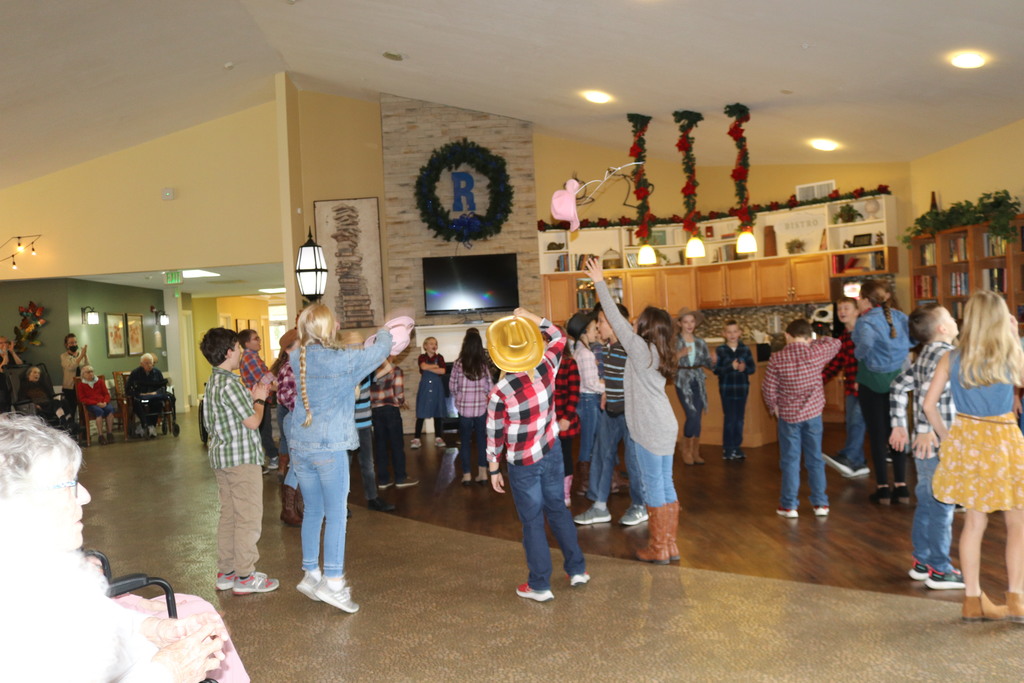 Students throw up their hat at their Randall Residence square dancing service trip