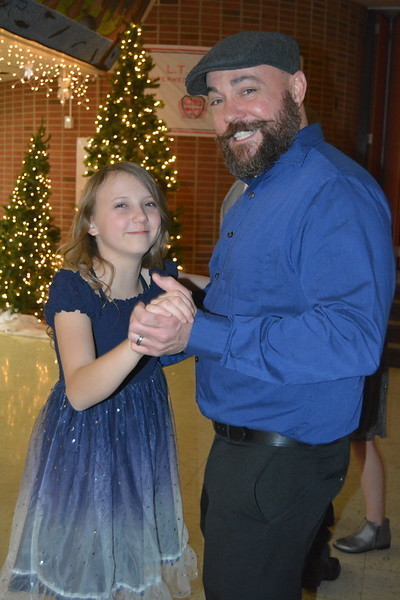 Father and daughter dance at the blizzard blast.