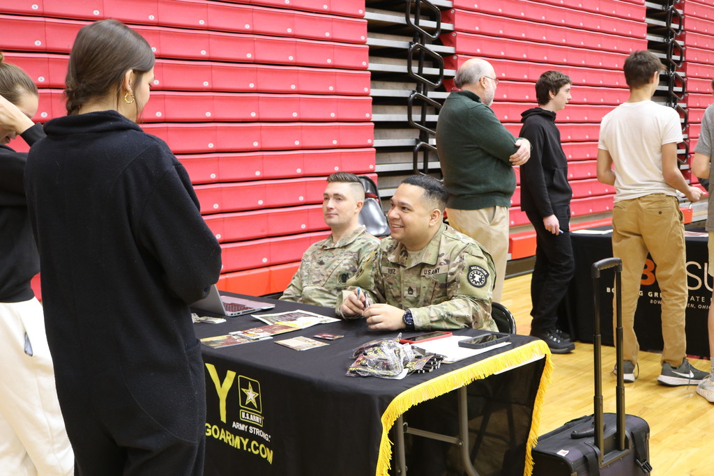 Army recruiters talk with students about a career path in the military.