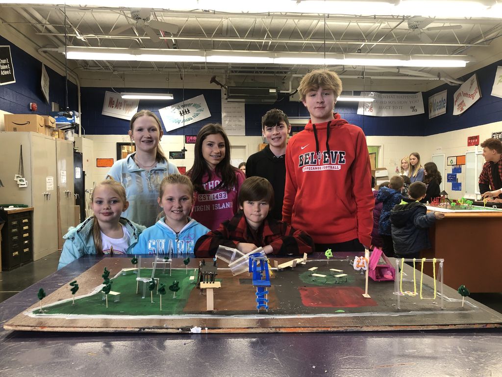 Students show off their playground design.  