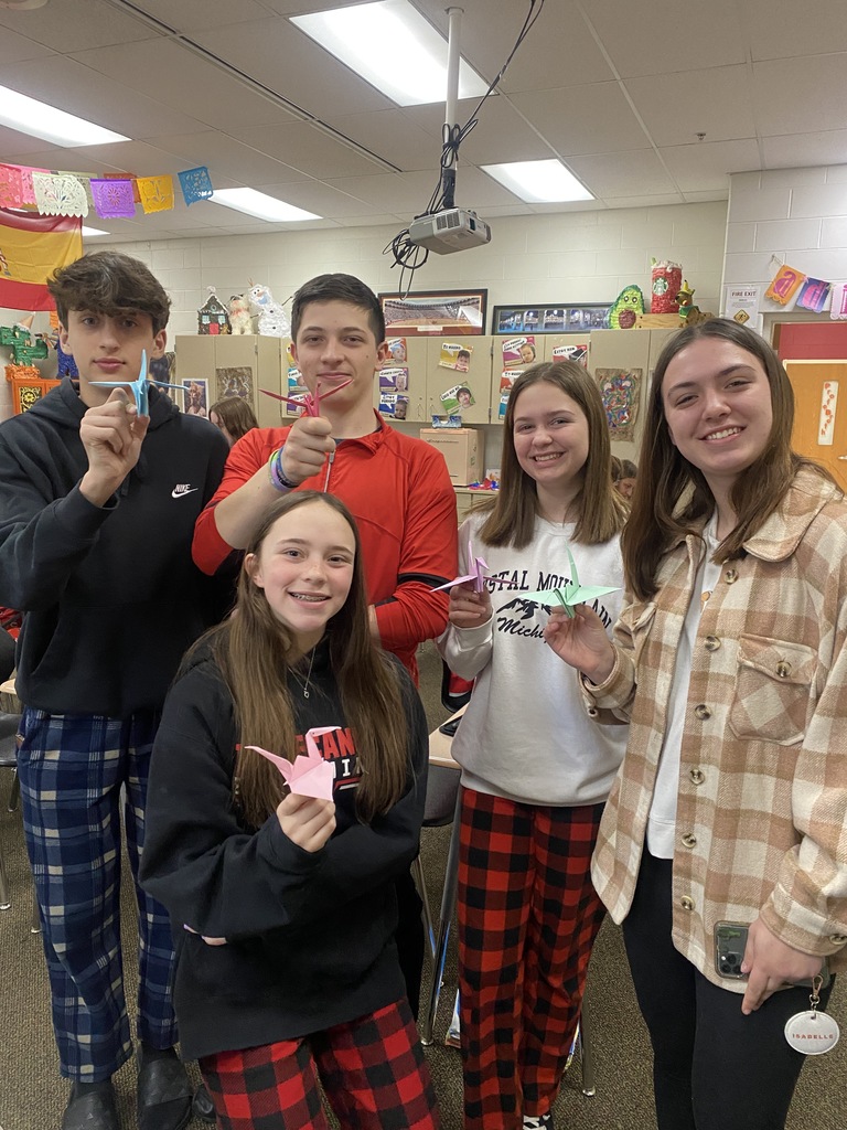 Four THS students show off their origami cranes they made.