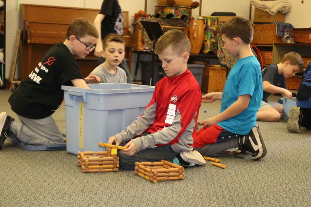 Kids building with Lincoln Logs.