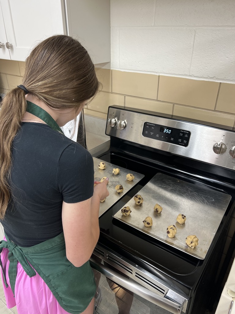 A student shapes the cookies before baking them. 