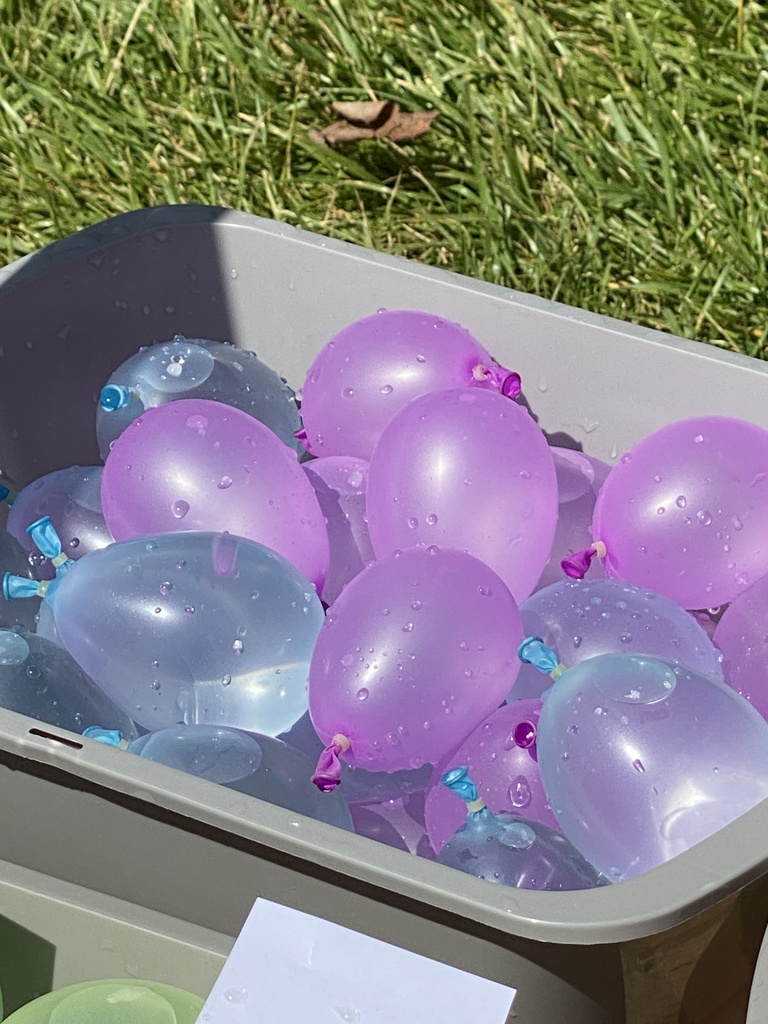 A bucket of water balloons.