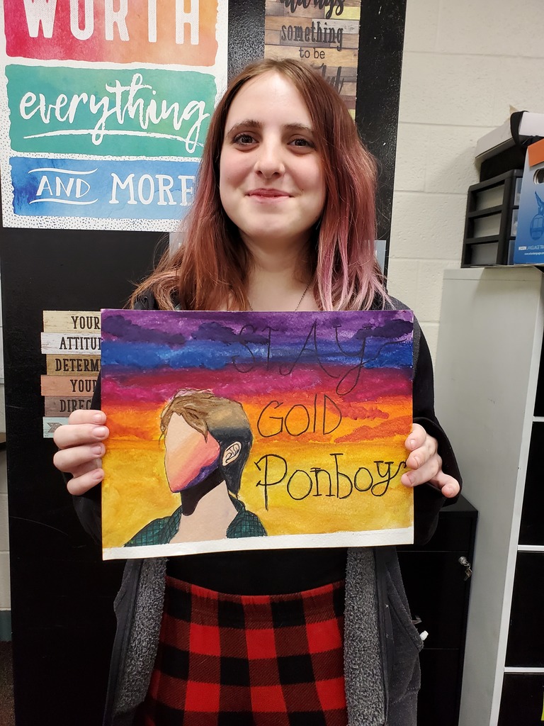 A TMS student shows off her Art project.