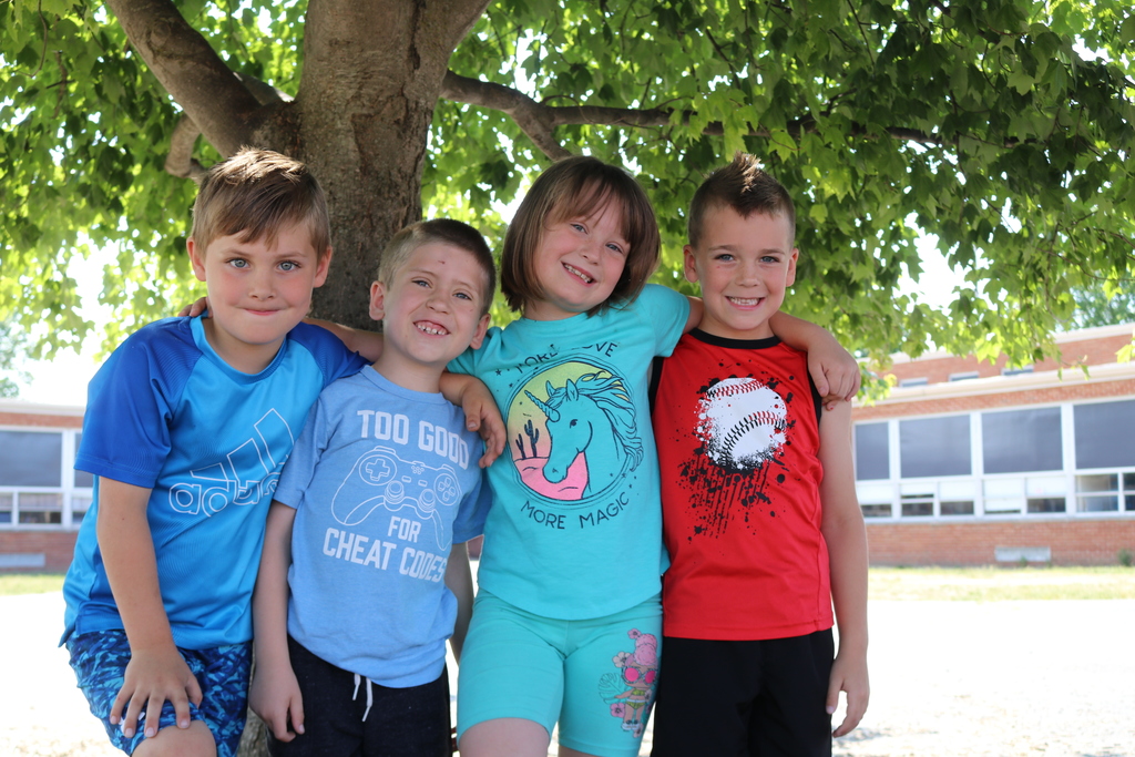 Four Nevin Coppock students smile for the camera.