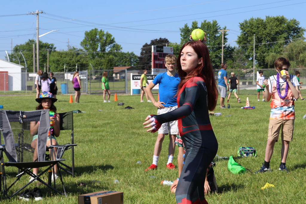 A TMS students throw a ball at the water tank.