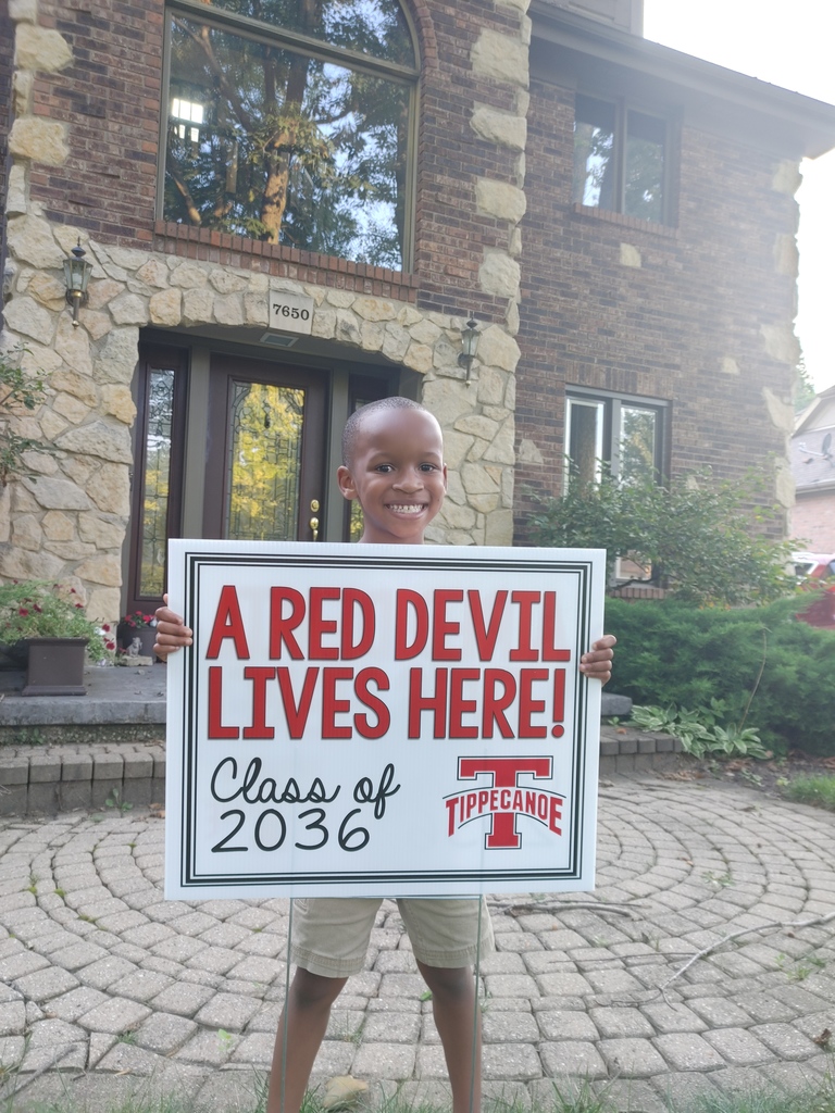 Incoming kindergarten students with his new shirt and sign.