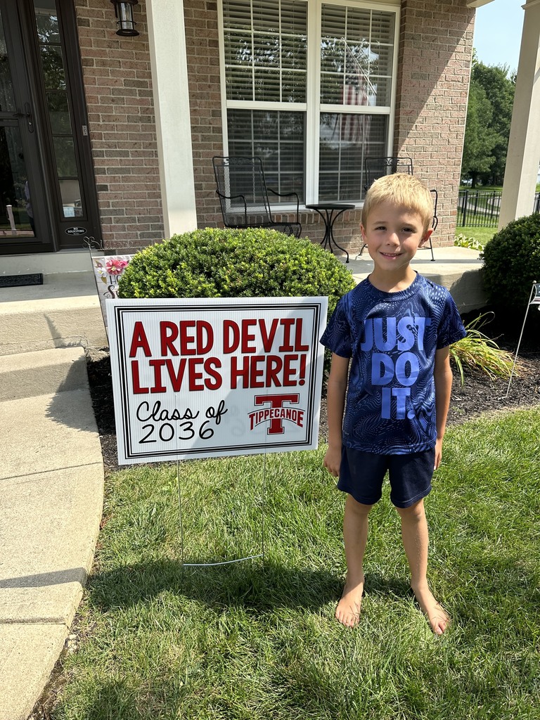 Incoming kindergarten students with his new shirt and sign.
