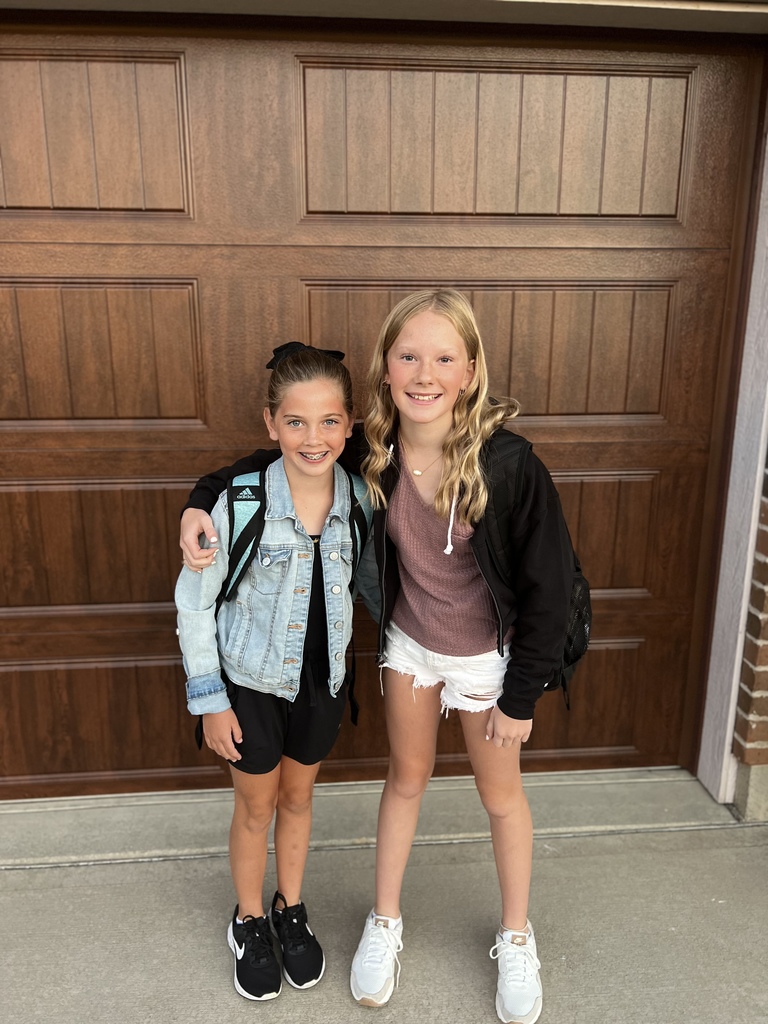 Two girls on the first day of school.  